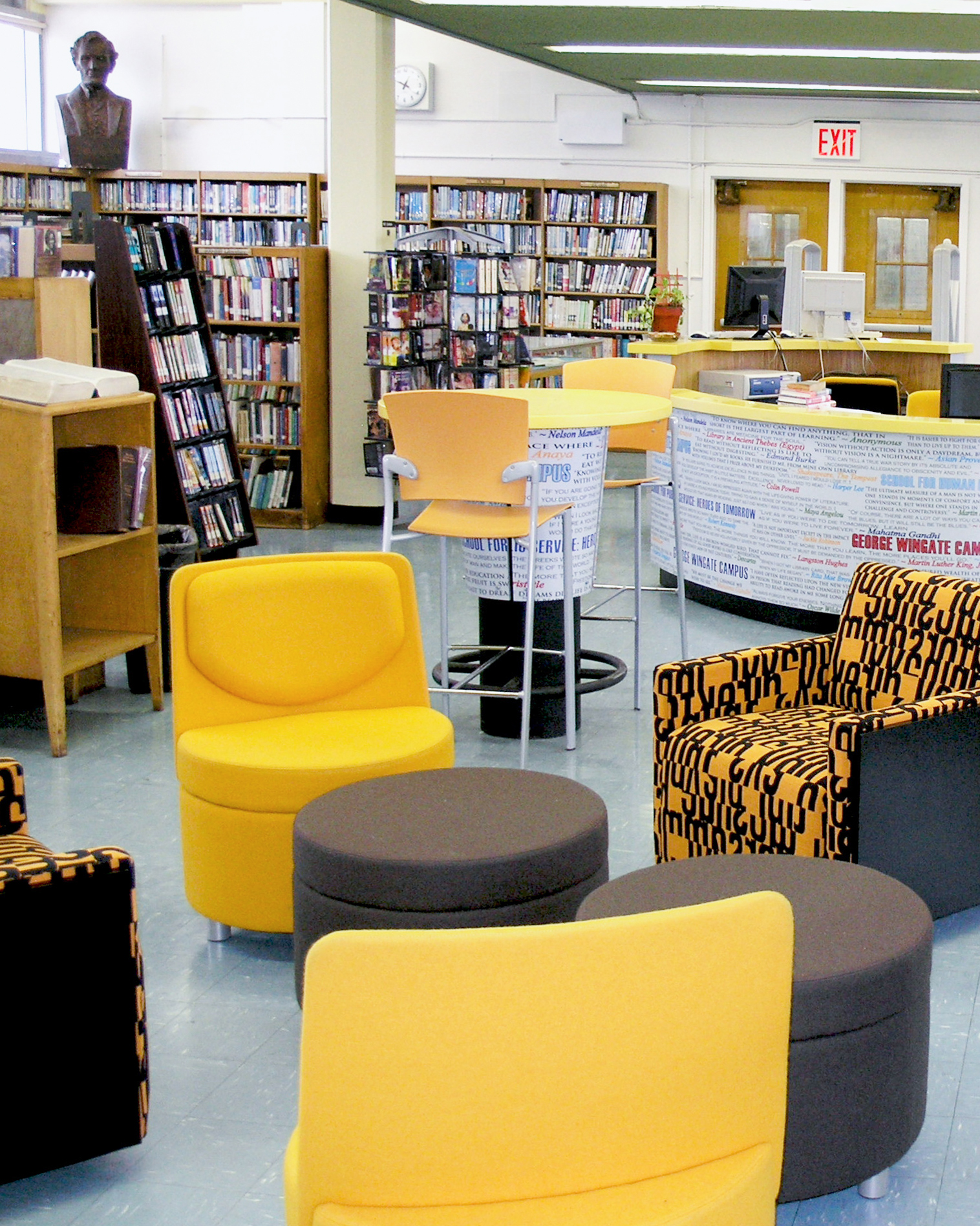 New Visions 24_V2 New Visions Public Libraries yellow seating area and help desk